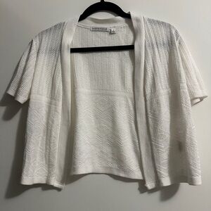 White cardigan with short sleeves and a crochet pattern